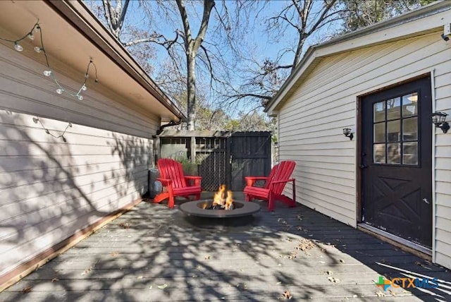 view of patio / terrace with a deck and a fire pit