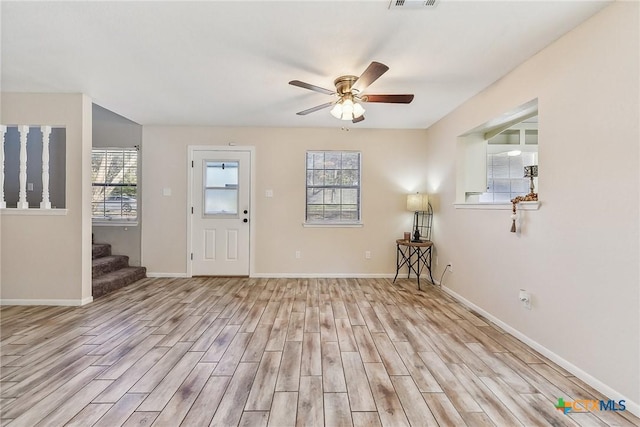 entryway with ceiling fan and light hardwood / wood-style floors