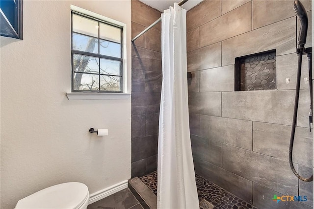 bathroom featuring toilet and a shower with curtain