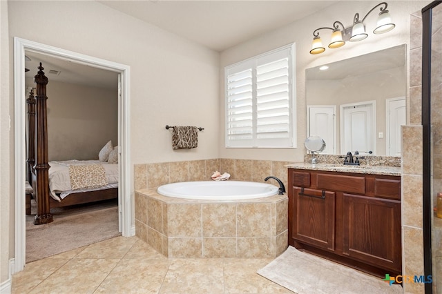 618 Oak Brook Dr, New Braunfels, TX 78132 - ensuite bathroom featuring tile patterned flooring, a garden tub, and vanity