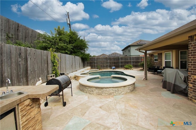 2711 Curtis Dr, Copperas Cove, TX 76522 - view of swimming pool with a patio area, a fenced backyard, a pool with connected hot tub, and area for grilling