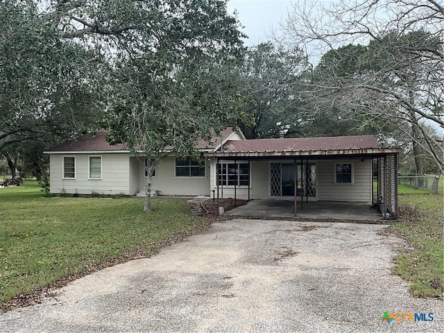 ranch-style house with a carport and a front lawn