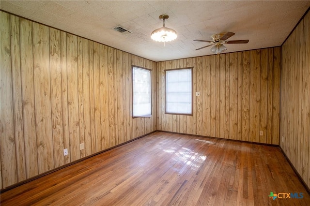 spare room featuring hardwood / wood-style flooring and ceiling fan