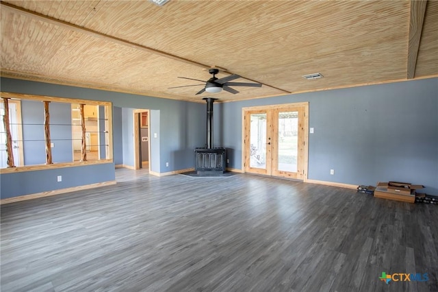 unfurnished living room with french doors, hardwood / wood-style flooring, a wood stove, and wooden ceiling