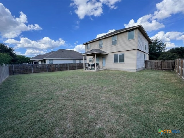 back of house with a yard