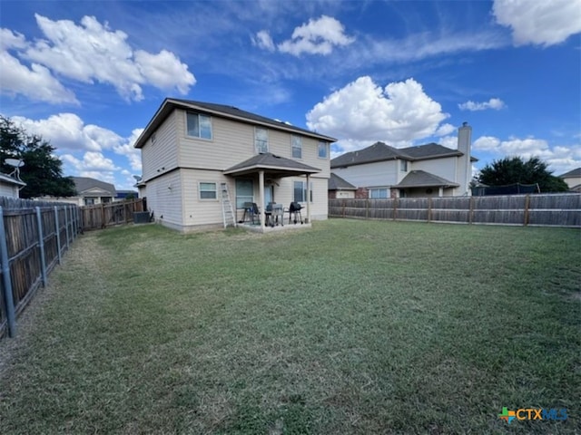 rear view of property featuring a yard