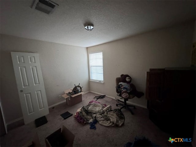 bedroom with carpet and a textured ceiling