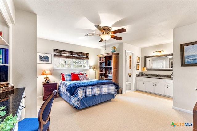 13755 N Lone Star Pkwy, Valley Mills, TX 76689 - bedroom featuring a sink, light colored carpet, ceiling fan, connected bathroom, and baseboards