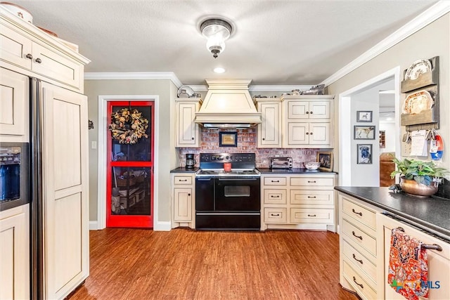 13755 N Lone Star Pkwy, Valley Mills, TX 76689 - kitchen with black electric range oven, custom exhaust hood, cream cabinetry, and dark countertops