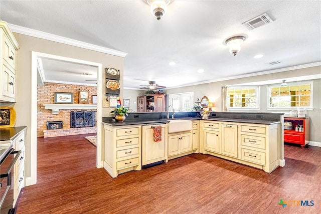13755 N Lone Star Pkwy, Valley Mills, TX 76689 - kitchen with a sink, dark countertops, paneled dishwasher, cream cabinetry, and visible vents