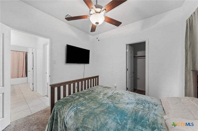 372 Poplin Ln, Troy, TX 76579 - carpeted bedroom featuring a walk in closet, tile patterned flooring, and ceiling fan