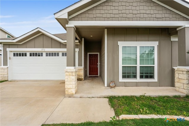 372 Poplin Ln, Troy, TX 76579 - view of front facade featuring board and batten siding, concrete driveway, and an attached garage