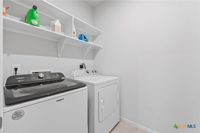 372 Poplin Ln, Troy, TX 76579 - laundry room with washing machine and dryer, baseboards, and light tile patterned floors