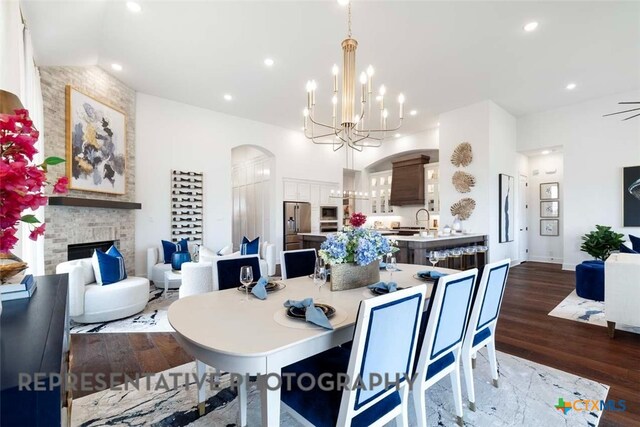 435 Nash Way, New Braunfels, TX 78130 - dining space featuring dark hardwood / wood-style flooring, ceiling fan with notable chandelier, and a stone fireplace