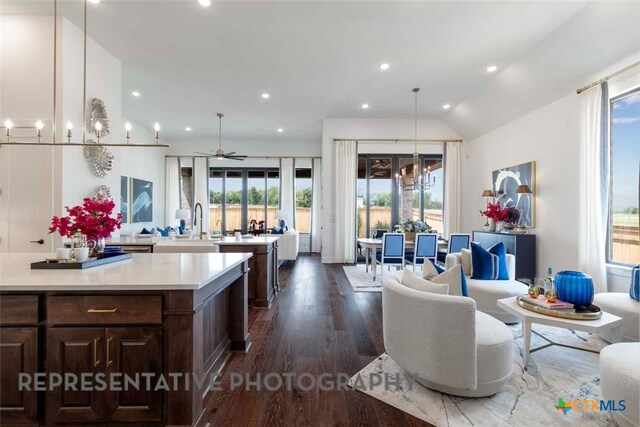 435 Nash Way, New Braunfels, TX 78130 - kitchen with decorative light fixtures, dark hardwood / wood-style flooring, vaulted ceiling, ceiling fan with notable chandelier, and sink