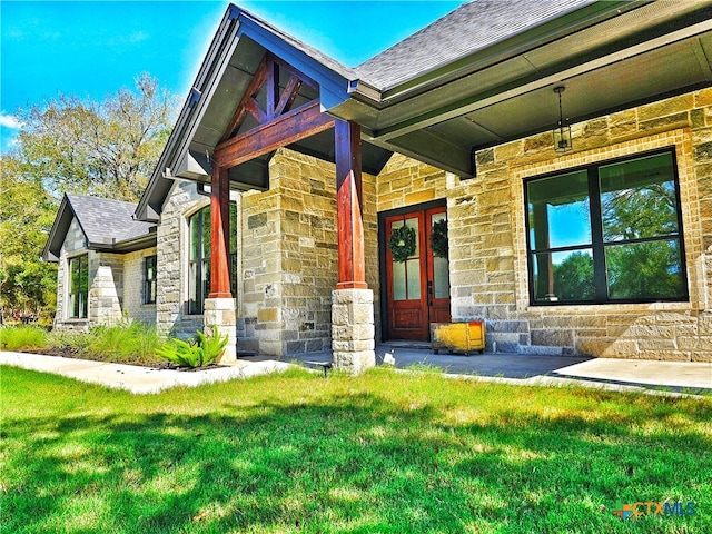 exterior space featuring a yard and french doors