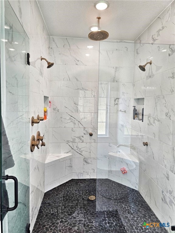 bathroom featuring a textured ceiling and walk in shower