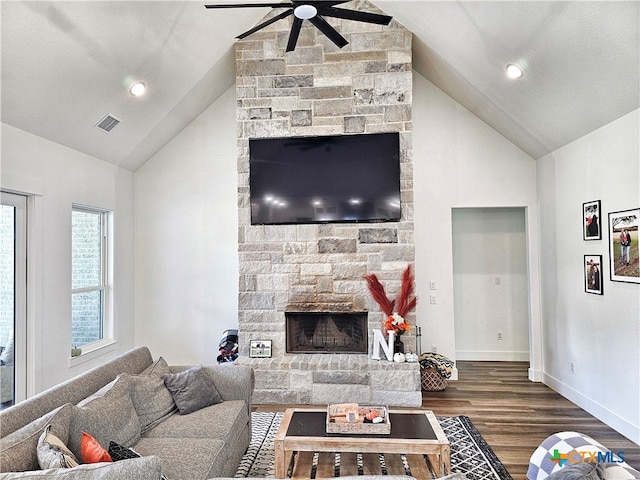 living room featuring ceiling fan, a fireplace, high vaulted ceiling, and dark hardwood / wood-style floors