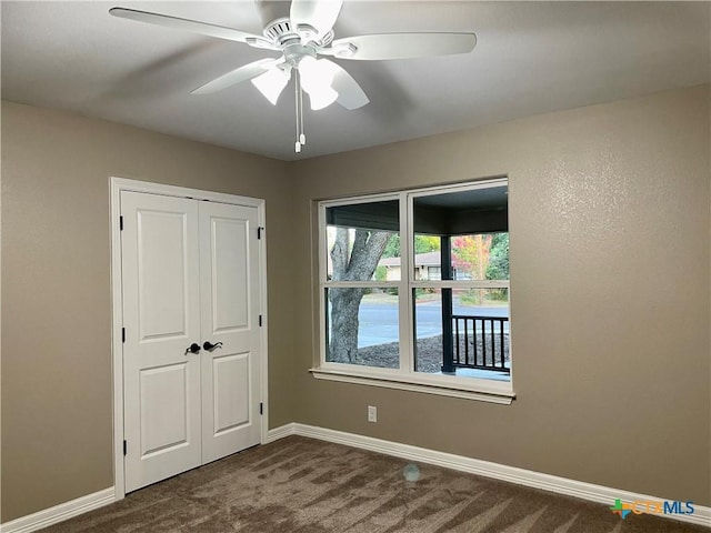 unfurnished bedroom featuring ceiling fan, a closet, and carpet