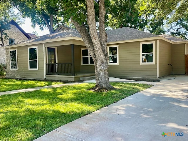 back of house featuring a lawn and covered porch