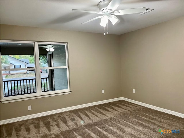 carpeted spare room with ceiling fan