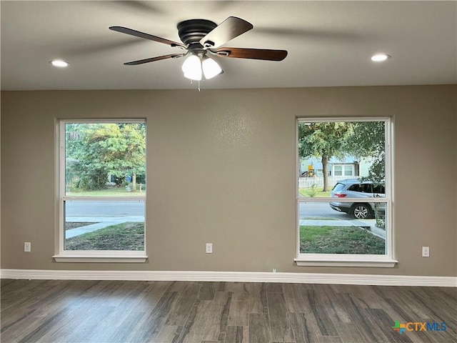 spare room featuring ceiling fan and dark hardwood / wood-style flooring