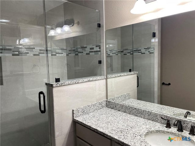 bathroom with vanity and an enclosed shower