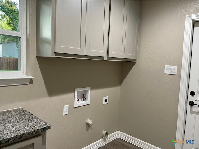 clothes washing area featuring electric dryer hookup, cabinets, dark wood-type flooring, hookup for a gas dryer, and hookup for a washing machine