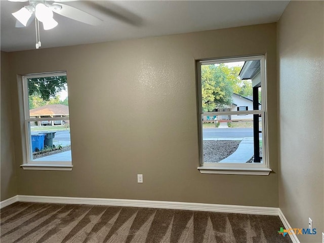 carpeted empty room featuring ceiling fan