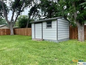 view of outbuilding featuring a lawn