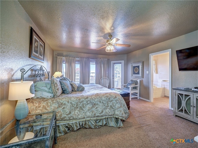 carpeted bedroom featuring ensuite bathroom, a textured ceiling, and ceiling fan