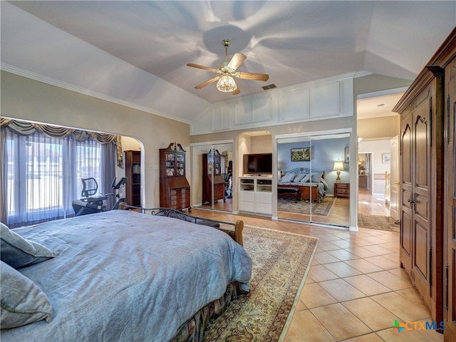 tiled bedroom featuring vaulted ceiling and ceiling fan