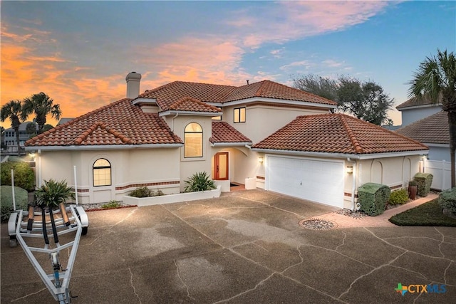 mediterranean / spanish-style house with a garage