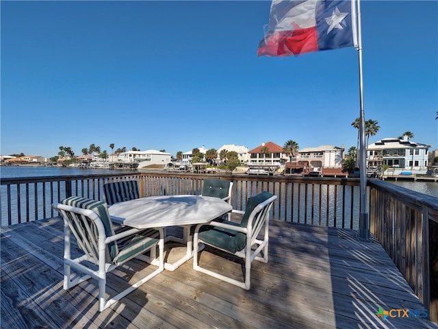 wooden terrace featuring a water view