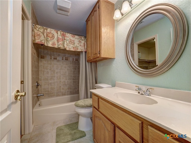 full bathroom featuring tile patterned floors, toilet, shower / tub combo, a textured ceiling, and vanity