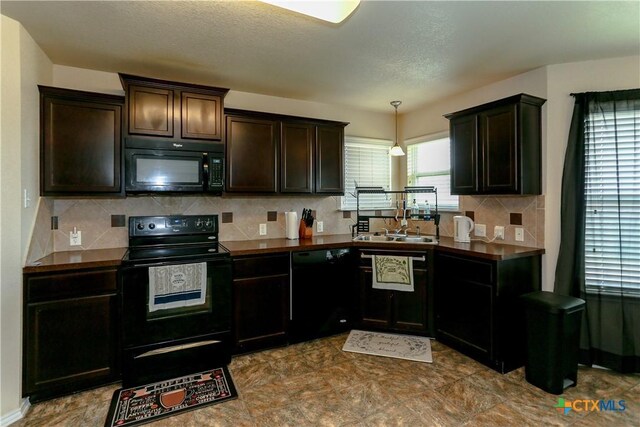 kitchen with dark brown cabinetry, dark countertops, decorative backsplash, and black appliances