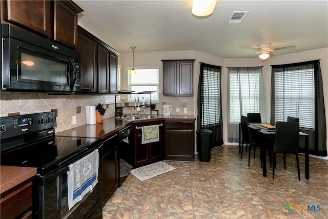 kitchen with a sink, tasteful backsplash, black appliances, visible vents, and dark brown cabinets