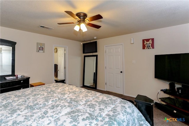 carpeted bedroom with visible vents, baseboards, and ceiling fan