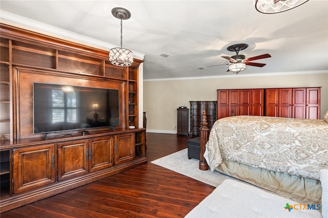 bedroom with ceiling fan with notable chandelier, dark hardwood / wood-style floors, and crown molding