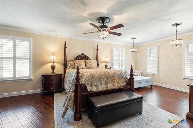 bedroom with ornamental molding, ceiling fan with notable chandelier, multiple windows, and dark hardwood / wood-style floors