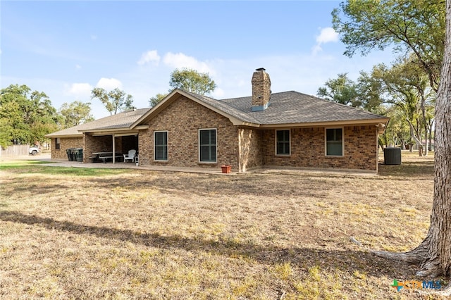 back of house featuring a patio area and a yard