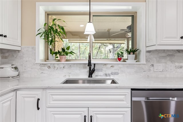 kitchen with dishwasher, pendant lighting, sink, and white cabinets