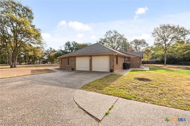 view of home's exterior featuring a garage and a yard