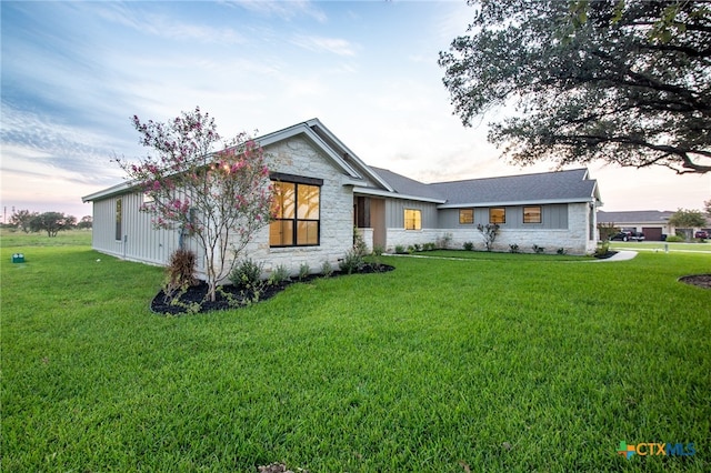 ranch-style home with a lawn