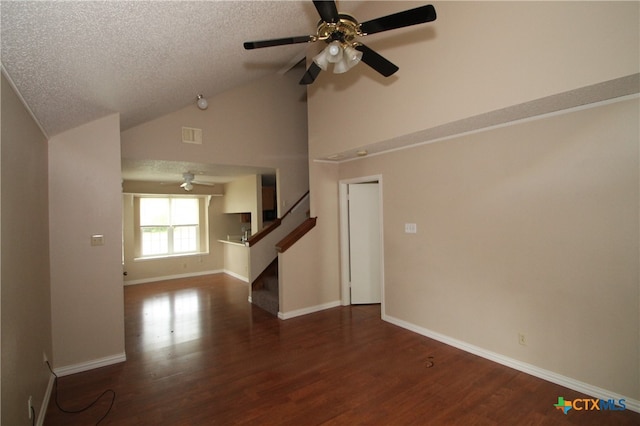 unfurnished living room with dark hardwood / wood-style floors, ceiling fan, lofted ceiling, and a textured ceiling