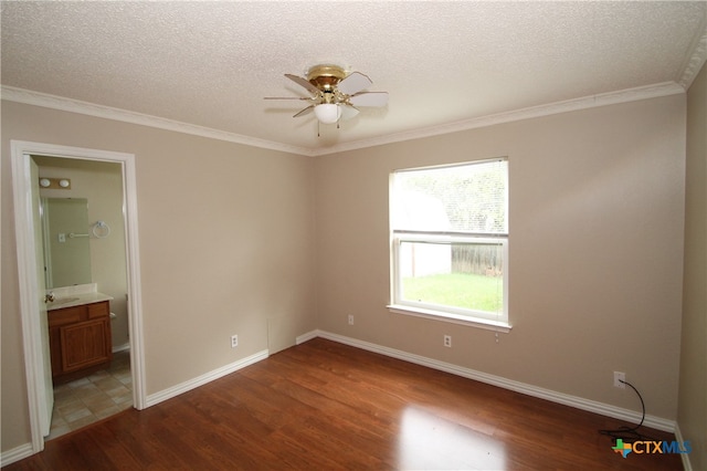 empty room with ceiling fan, crown molding, wood-type flooring, and a textured ceiling