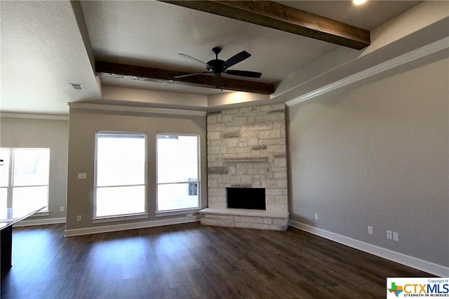 unfurnished living room featuring a fireplace, crown molding, beam ceiling, dark hardwood / wood-style flooring, and ceiling fan