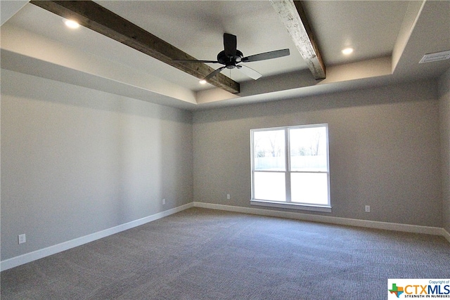 spare room with carpet floors, ceiling fan, a raised ceiling, and beam ceiling