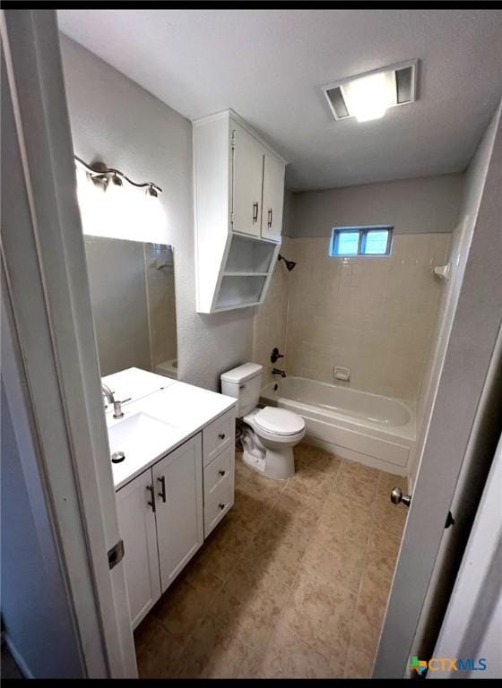 full bathroom featuring tiled shower / bath combo, toilet, and vanity