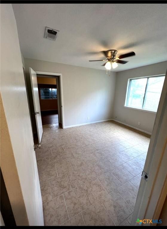 empty room featuring ceiling fan